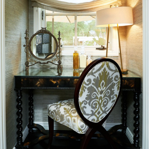 A chair and table in front of a window.